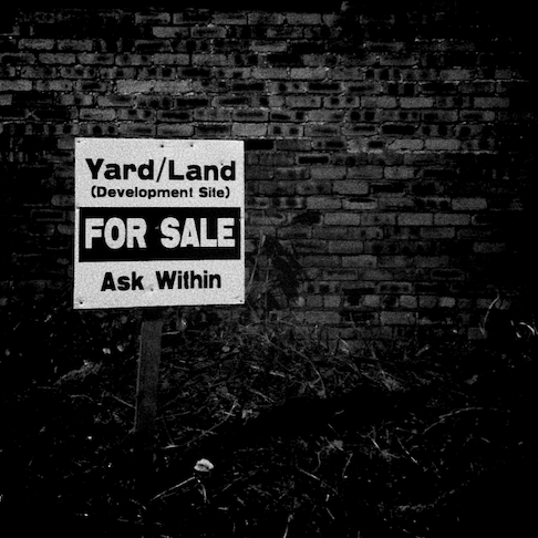black and white image of a for sale sign